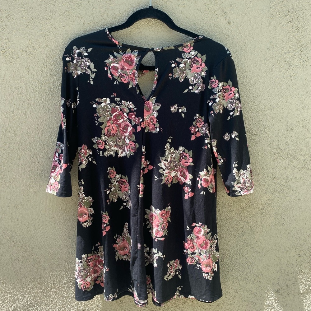 Short Black dress with flower pattern.Fits more like a small.Flowy bottom